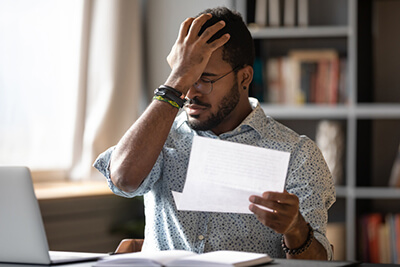 man stressing about a business pitfall